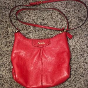 Small Red crossbody Coach purse.